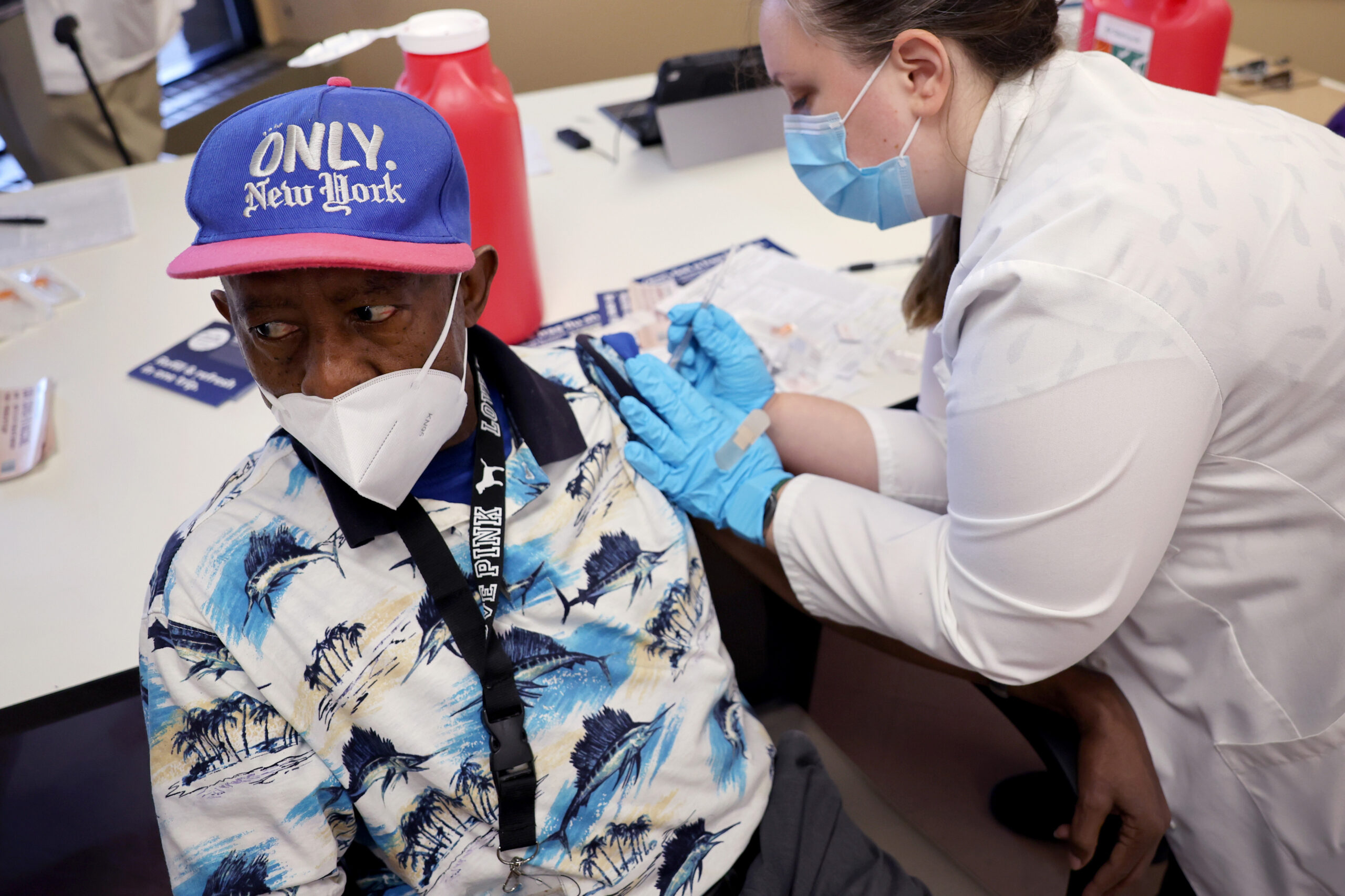 Photograph of man getting COVID-19 booster